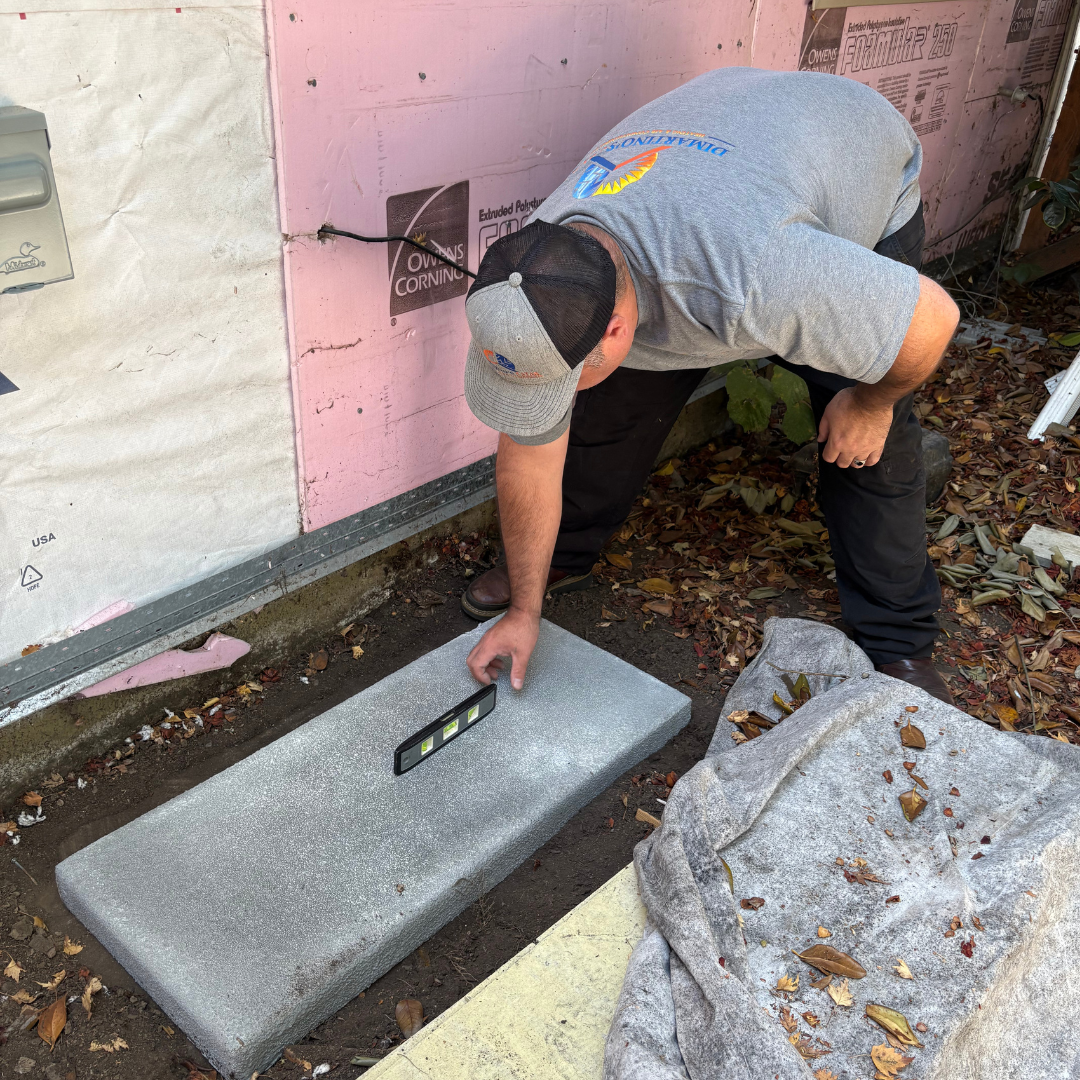 Precise AC Installation Preparation Salem Oregon - Professional HVAC Service Professional HVAC technician using precision tools to prepare outdoor unit installation pad in Salem Oregon
