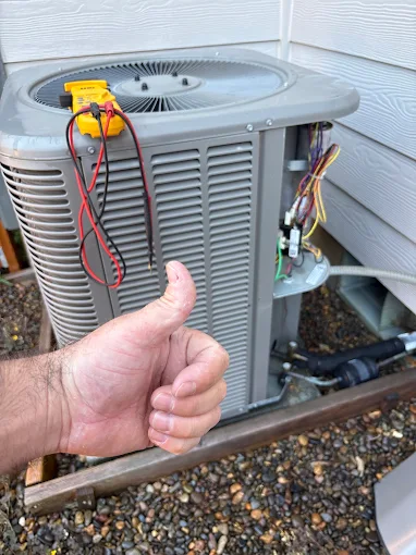 HVAC technician giving thumbs up after successful AC repair