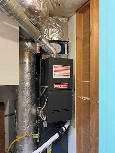 Expert Goodman Furnace Installation - Salem Oregon Professional HVAC Services Professional HVAC technician installing Goodman furnace system Salem Oregon basement installation