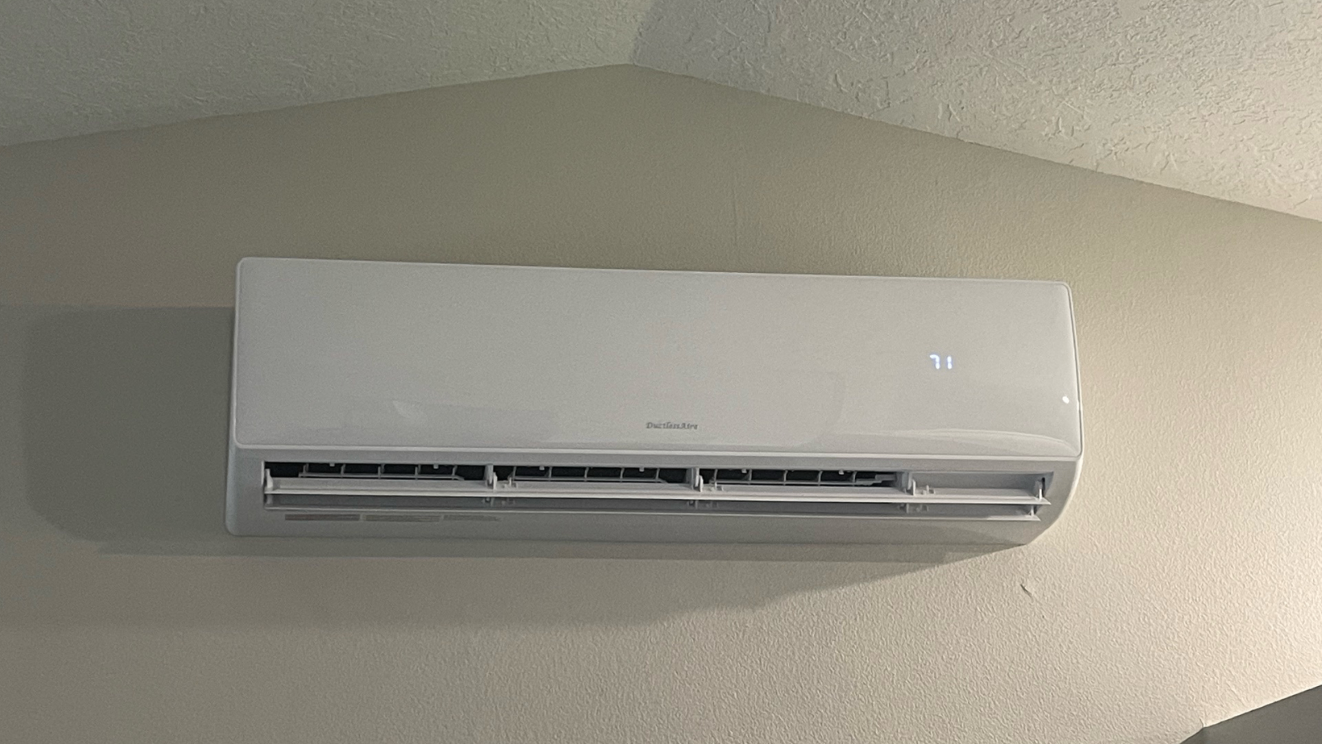 Modern ductless mini-split indoor unit with digital temperature display